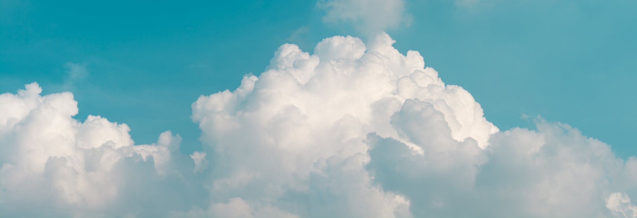 Towering cumulus clouds in a blue sky